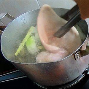 Nấu cho nước sôi thì thả tai heo vào luộc chín